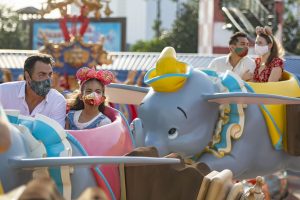 People enjoying a ride with Dumbo the elephant
