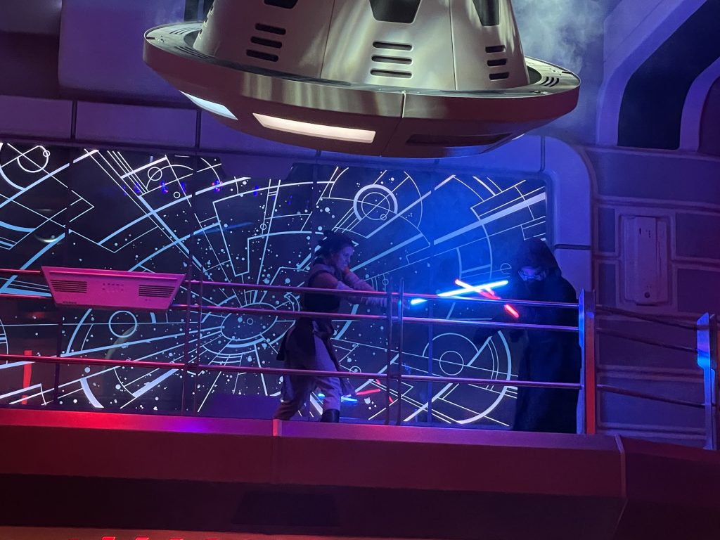 Rey and Kylo Ren battling aboard the Star Wars Galactic Starcruiser