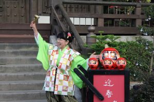 A story teller in the Japan pavilion teaches about the Daruma doll